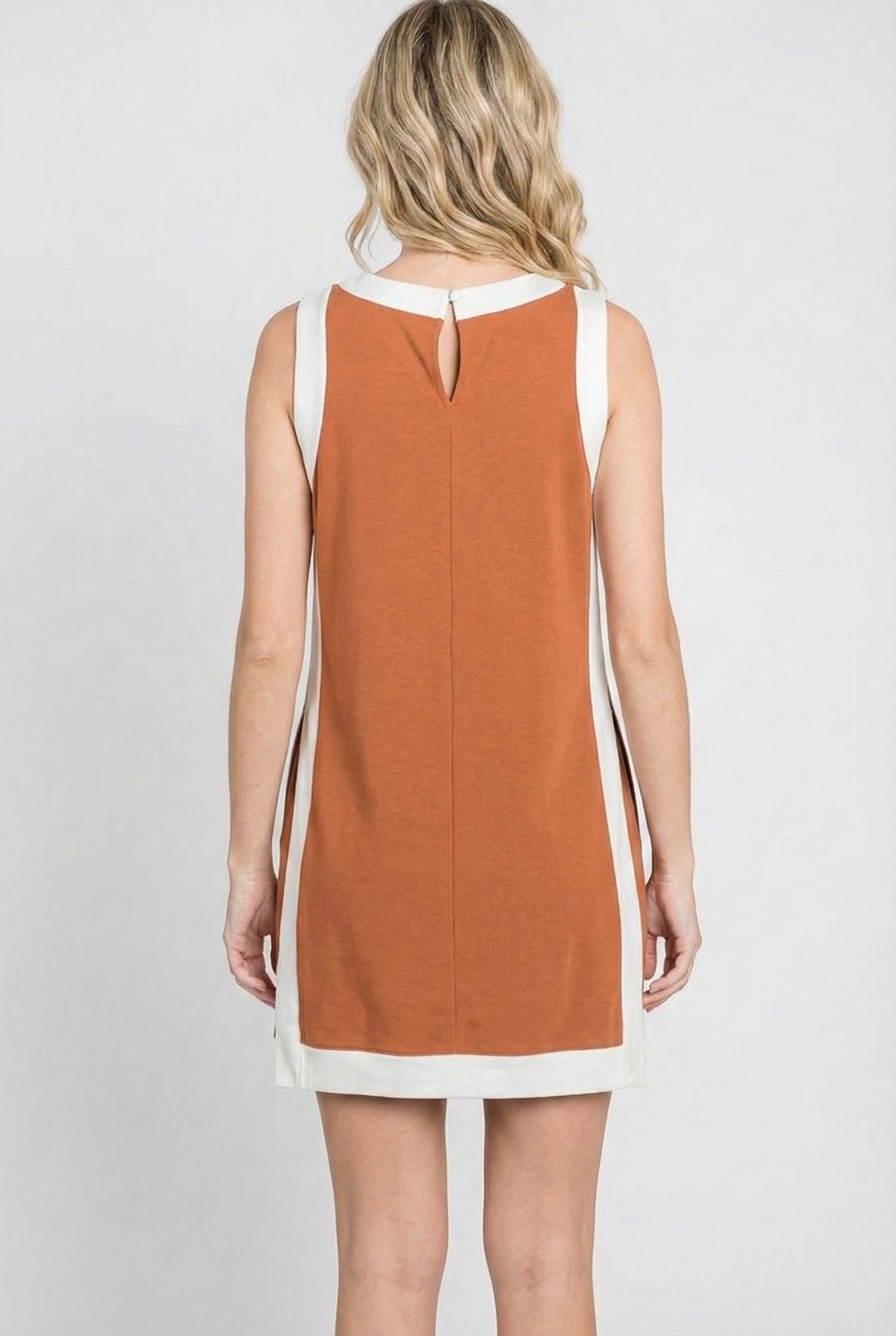 Model wearing the Lohnr Game Day Set in Burnt Orange, a 100% cotton two-piece outfit featuring hidden shorts with pockets.