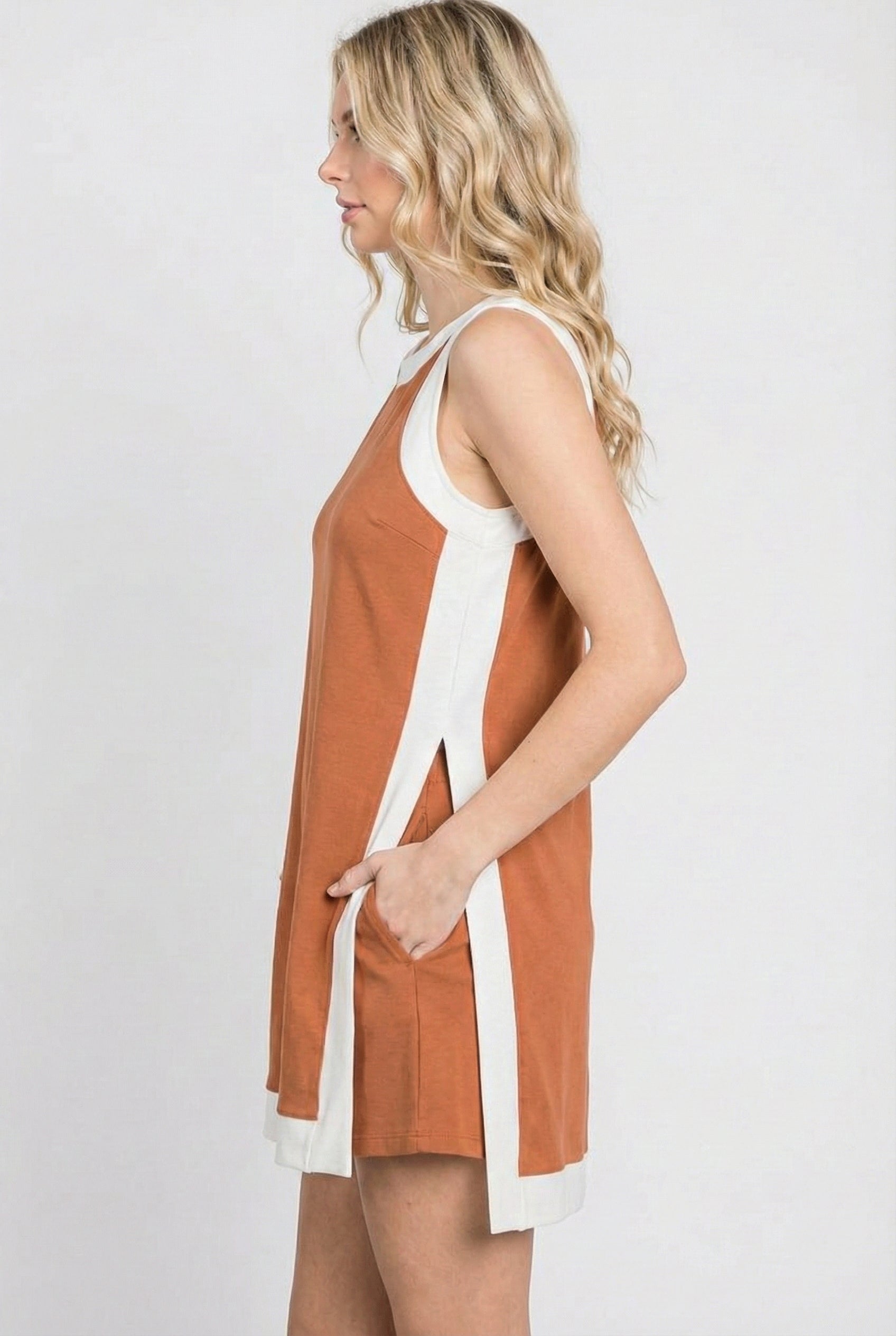 Model wearing the Lohnr Game Day Set in Burnt Orange, a 100% cotton two-piece outfit featuring hidden shorts with pockets.