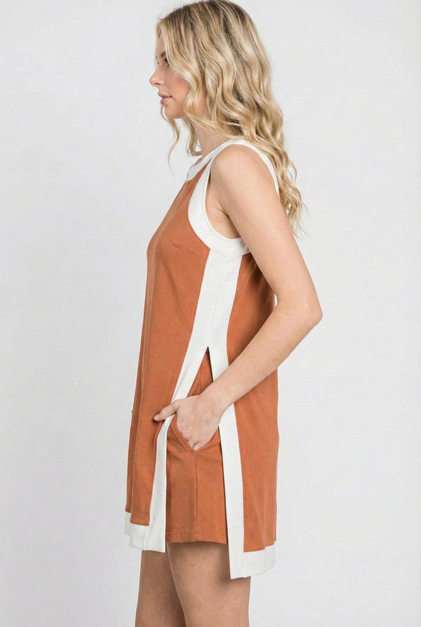 Model wearing the Lohnr Game Day Set in Burnt Orange, a 100% cotton two-piece outfit featuring hidden shorts with pockets.