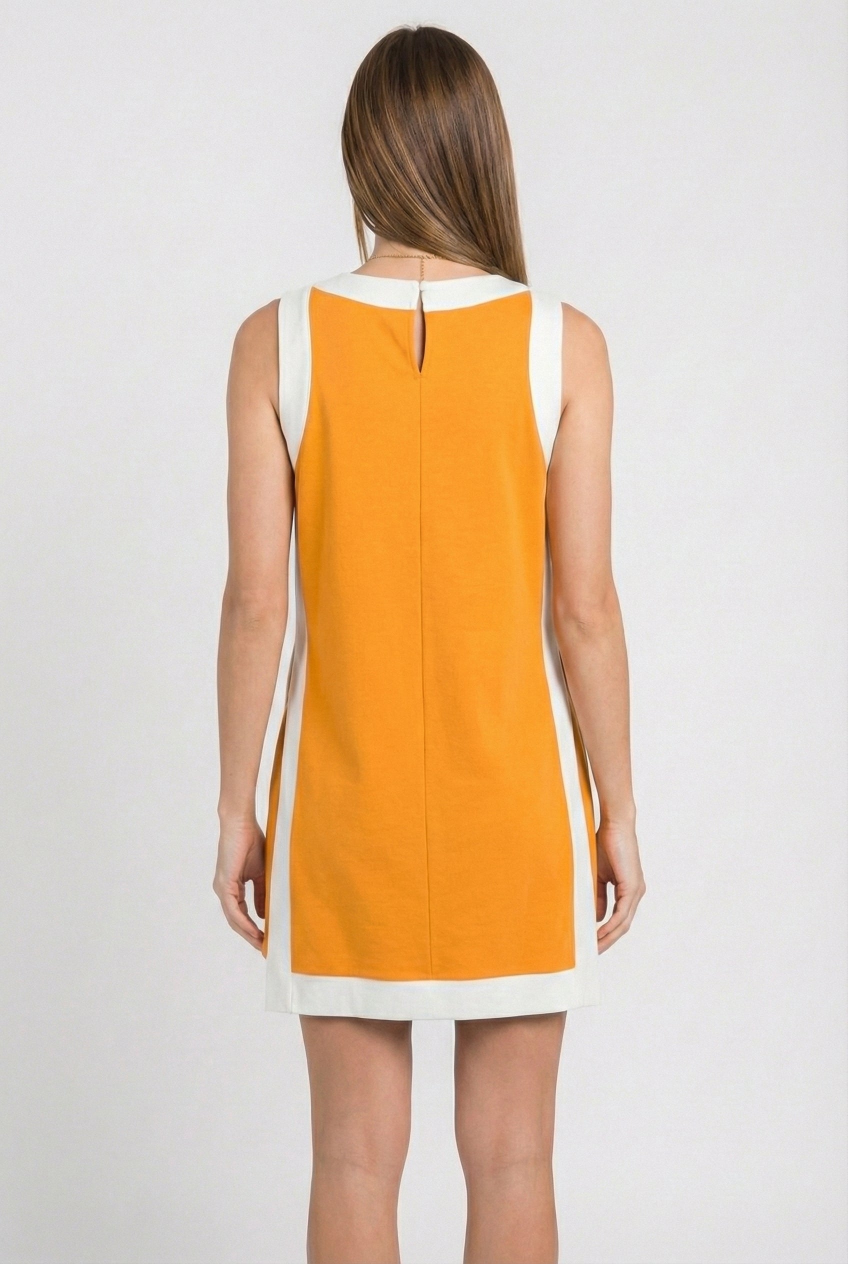 Model wearing the Lohnr Game Day Set in Orange, a 100% cotton two-piece outfit featuring hidden shorts with pockets.