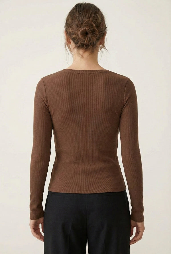 Woman wearing the LOHNR Haven Henley in Truffle, a rich brown ribbed long-sleeve top with a button placket, styled for effortless everyday luxury.