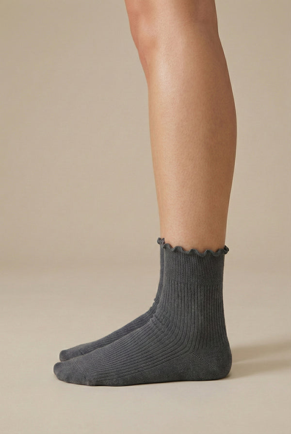 LOHNR Lacey Sock in Ash - A light grey ribbed crew sock designed for lasting comfort, featuring a delicate ruffle trim and a breathable cotton-blend fabric.