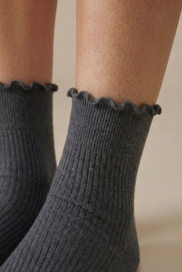 LOHNR Lacey Sock in Ash - A light grey ribbed crew sock designed for lasting comfort, featuring a delicate ruffle trim and a breathable cotton-blend fabric.