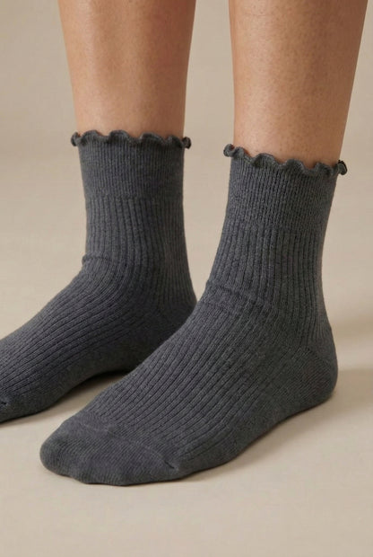 LOHNR Lacey Sock in Ash - A light grey ribbed crew sock designed for lasting comfort, featuring a delicate ruffle trim and a breathable cotton-blend fabric.
