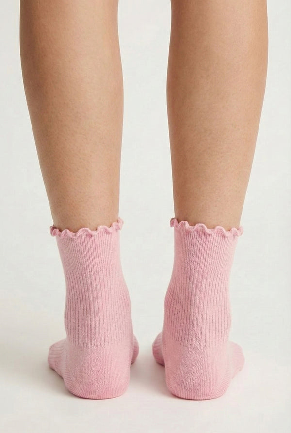 LOHNR Lacey Sock in Blush - A soft, pale pink ruffle-edge crew sock featuring a sculpted rib texture and stay-up cuff for refined everyday comfort.