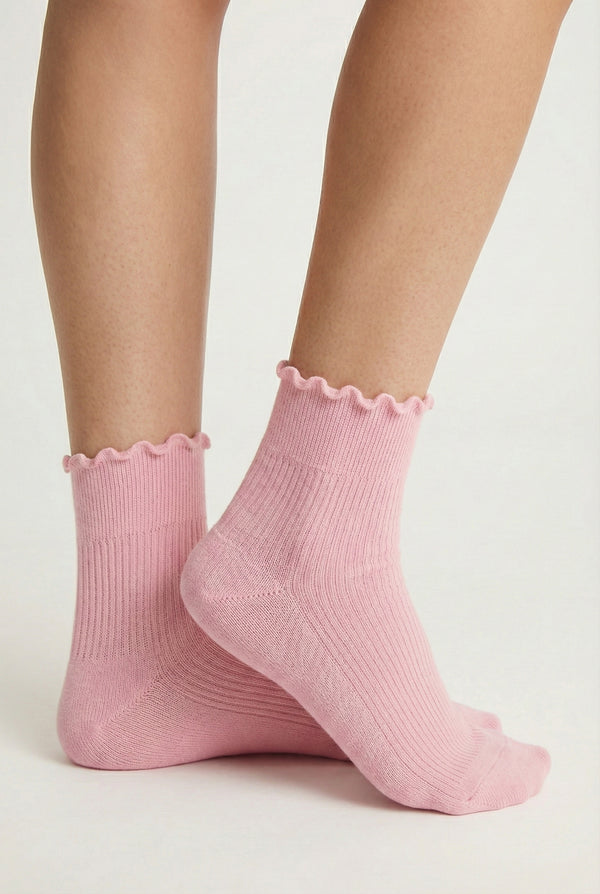 LOHNR Lacey Sock in Blush - A soft, pale pink ruffle-edge crew sock featuring a sculpted rib texture and stay-up cuff for refined everyday comfort.