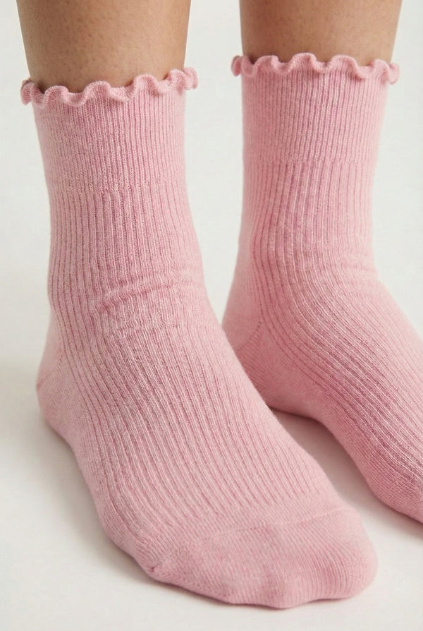 LOHNR Lacey Sock in Blush - A soft, pale pink ruffle-edge crew sock featuring a sculpted rib texture and stay-up cuff for refined everyday comfort.