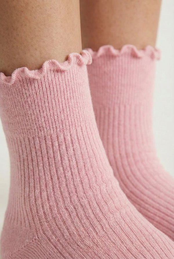 LOHNR Lacey Sock in Blush - A soft, pale pink ruffle-edge crew sock featuring a sculpted rib texture and stay-up cuff for refined everyday comfort.