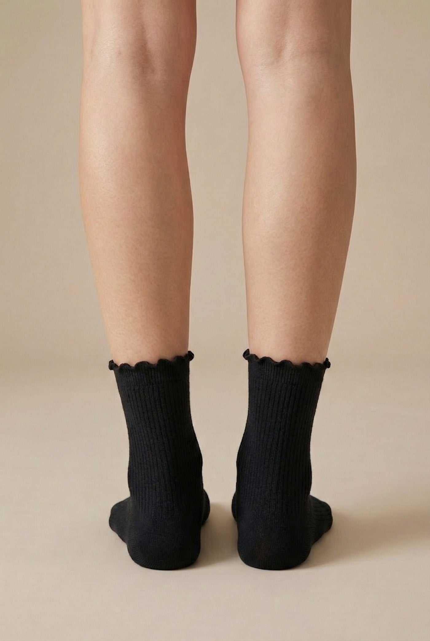 LOHNR Lacey Sock in Charcoal - A dark grey ruffle-edge crew sock that balances functional stretch with an elegant, textured ribbed design for elevated loungewear styling.