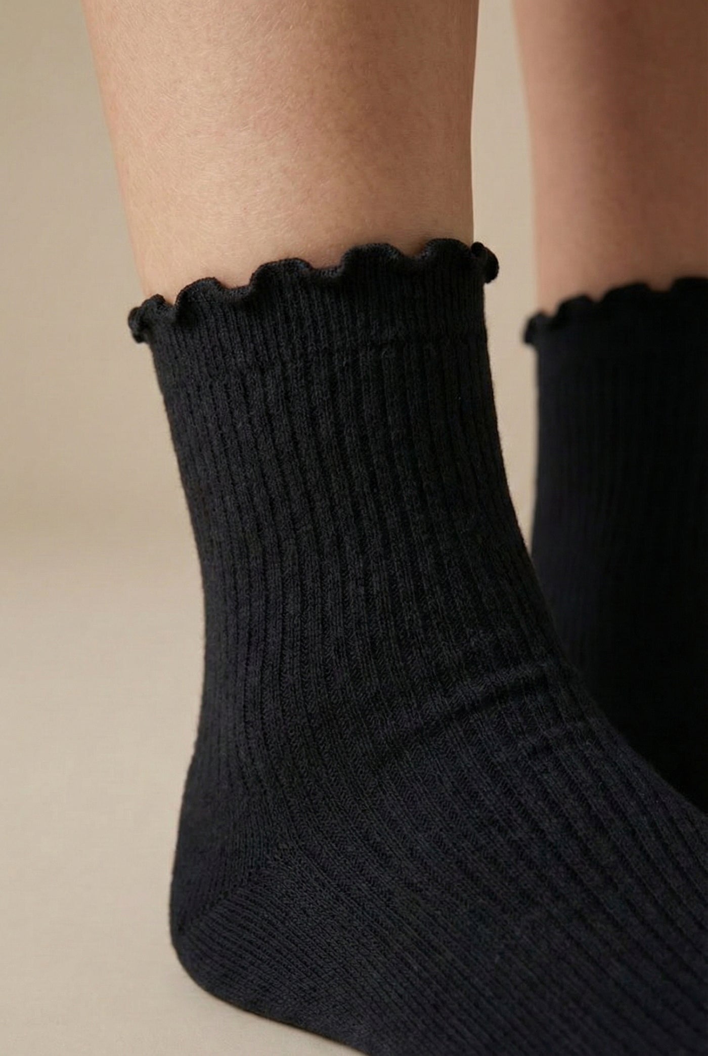 LOHNR Lacey Sock in Charcoal - A dark grey ruffle-edge crew sock that balances functional stretch with an elegant, textured ribbed design for elevated loungewear styling.