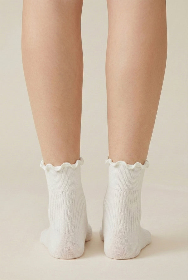 LOHNR Lacey Sock in Crema - An effortless off-white ruffle-edge crew sock offering quiet luxury with its sculpted rib texture and flexible, all-day stretch.