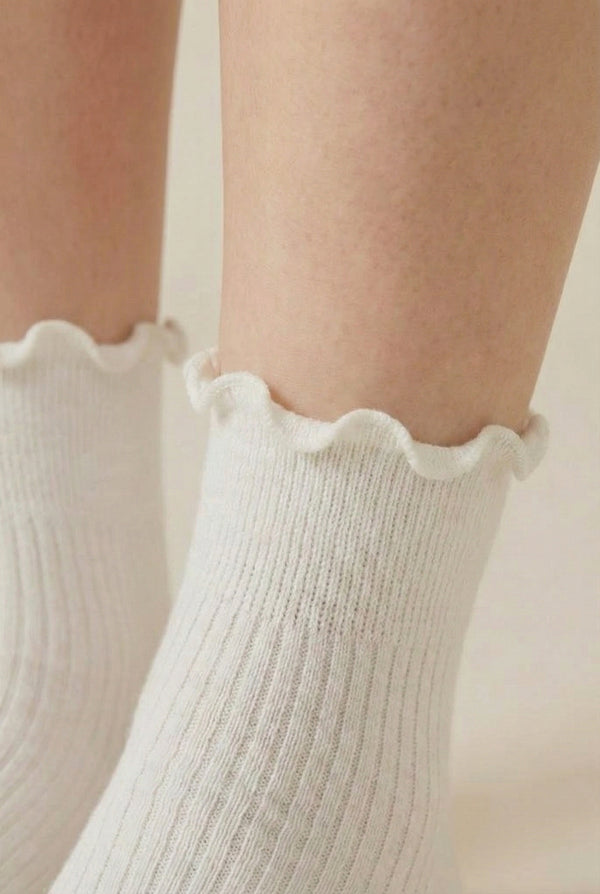 LOHNR Lacey Sock in Crema - An effortless off-white ruffle-edge crew sock offering quiet luxury with its sculpted rib texture and flexible, all-day stretch.