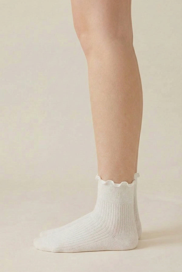 LOHNR Lacey Sock in Crema - An effortless off-white ruffle-edge crew sock offering quiet luxury with its sculpted rib texture and flexible, all-day stretch.