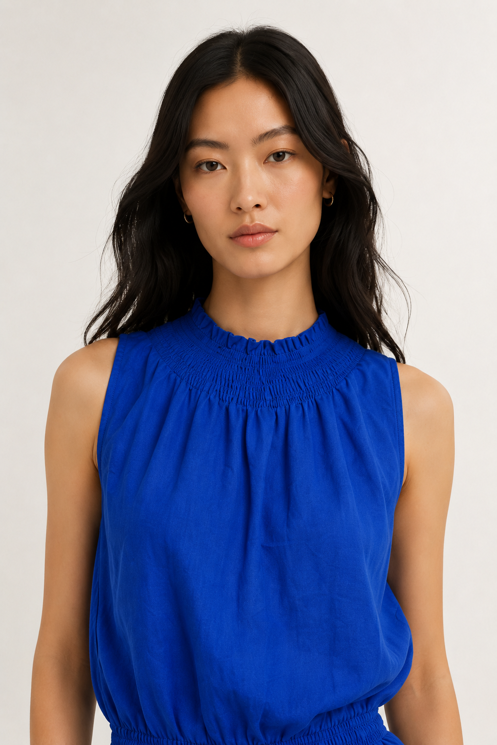 Woman wearing a premium minimalist lapis blue two piece set with sleeveless top and wide leg pants