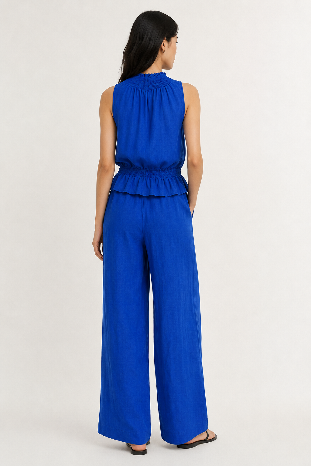 Woman wearing a premium minimalist lapis blue two piece set with sleeveless top and wide leg pants