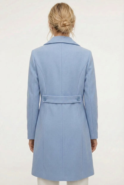 Coast light blue Mercer Coat by LOHNR, a tailored faux wool trench coat featuring structured lapels, deep utility pockets, and a refined quiet luxury aesthetic.