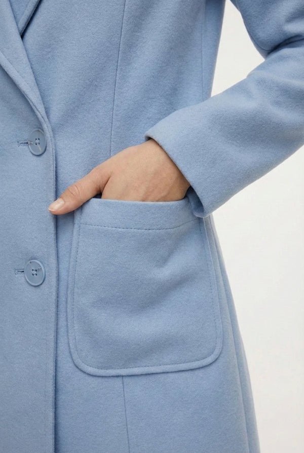 Coast light blue Mercer Coat by LOHNR, a tailored faux wool trench coat featuring structured lapels, deep utility pockets, and a refined quiet luxury aesthetic.