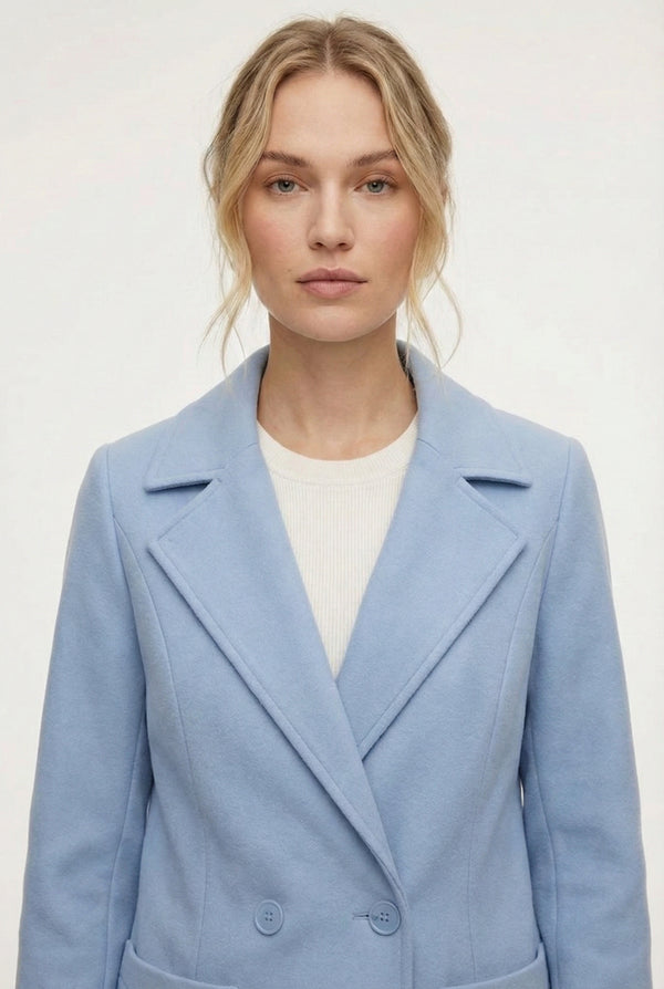 Coast light blue Mercer Coat by LOHNR, a tailored faux wool trench coat featuring structured lapels, deep utility pockets, and a refined quiet luxury aesthetic.