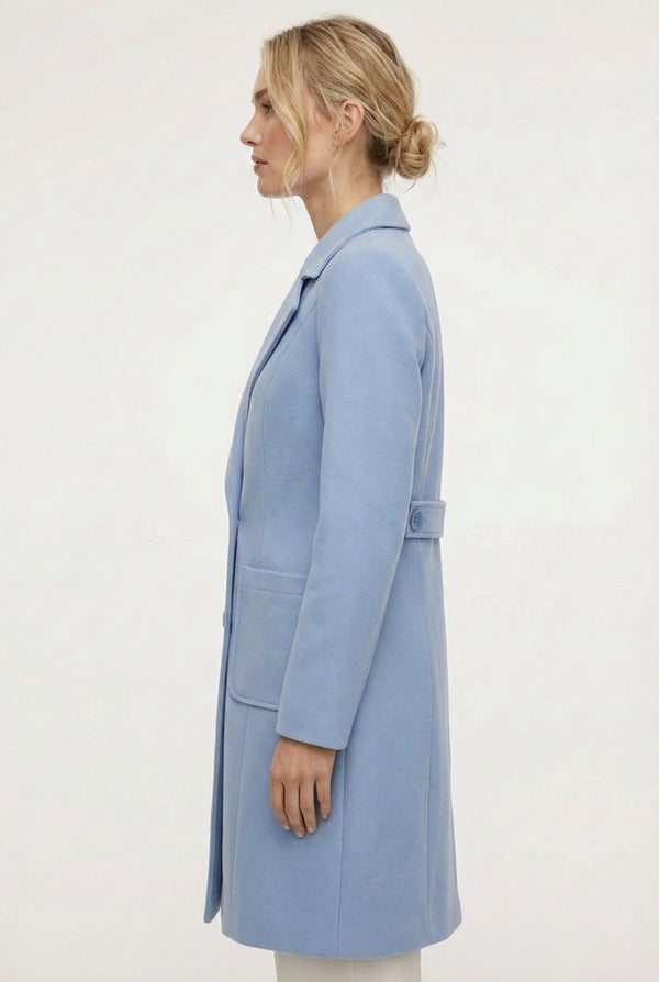 Coast light blue Mercer Coat by LOHNR, a tailored faux wool trench coat featuring structured lapels, deep utility pockets, and a refined quiet luxury aesthetic.
