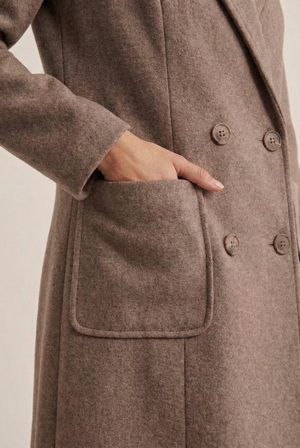 Fawn taupe Mercer Coat by LOHNR, a tailored faux wool trench coat featuring structured lapels, deep utility pockets, and a refined quiet luxury aesthetic.