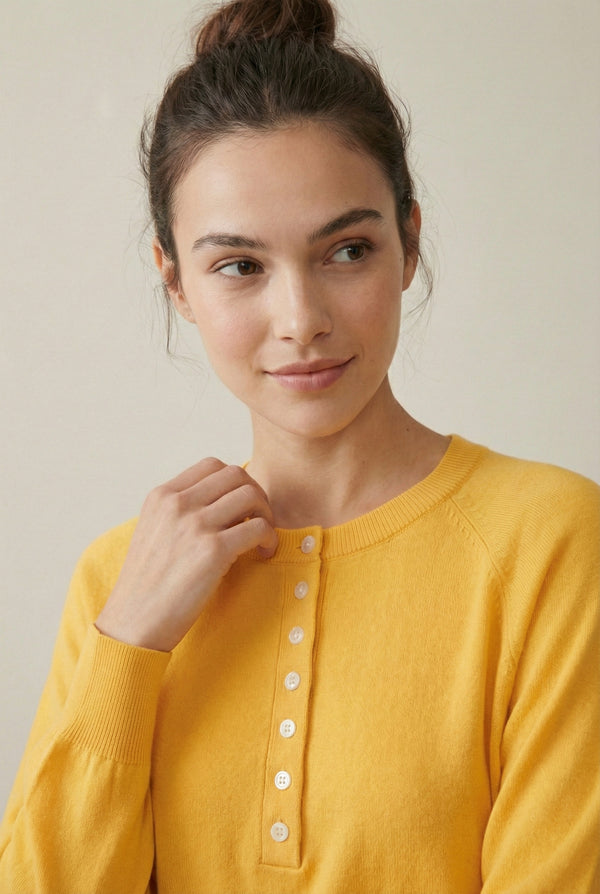 Women's smooth Roux Henley Sweater in Butter by LOHNR, featuring a relaxed blouson fit, dropped shoulders, and a half-button placket.