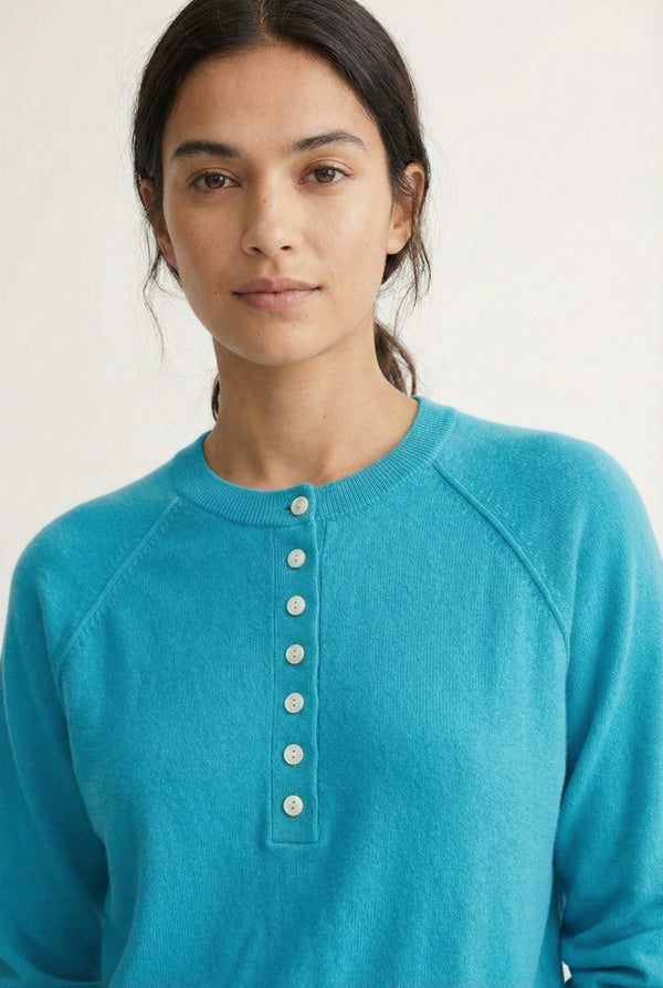 Women's smooth Roux Henley Sweater in Cerulean by LOHNR, featuring a relaxed blouson fit, dropped shoulders, and a half-button placket.