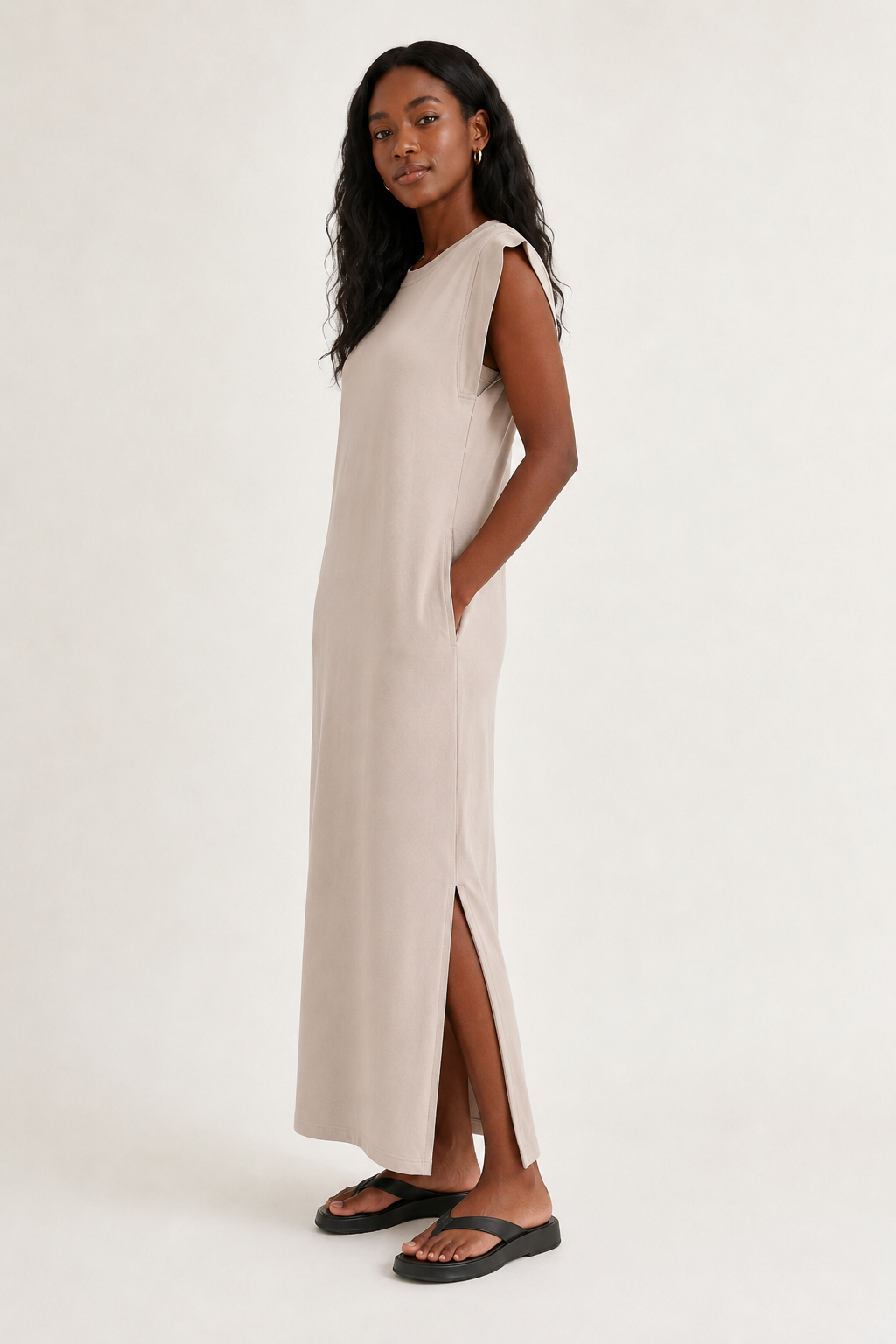 Professional studio shot of a model wearing the Lohnr Rowan Midi dress in Dune, featuring a premium relaxed drape and side split hem.