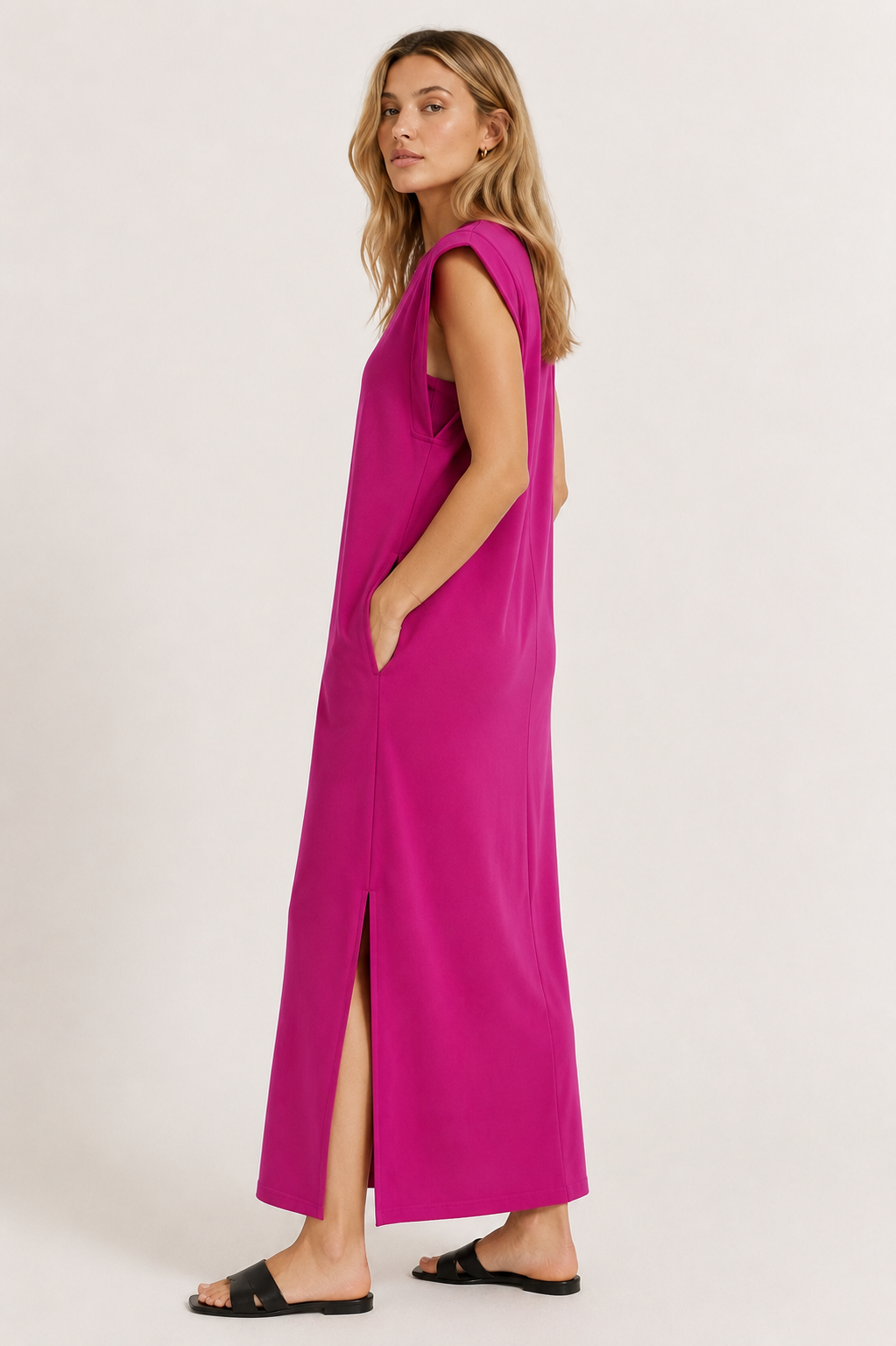 Professional studio shot of a model wearing the Lohnr Rowan Midi dress in Eros Pink, featuring a premium relaxed drape and side split hem.