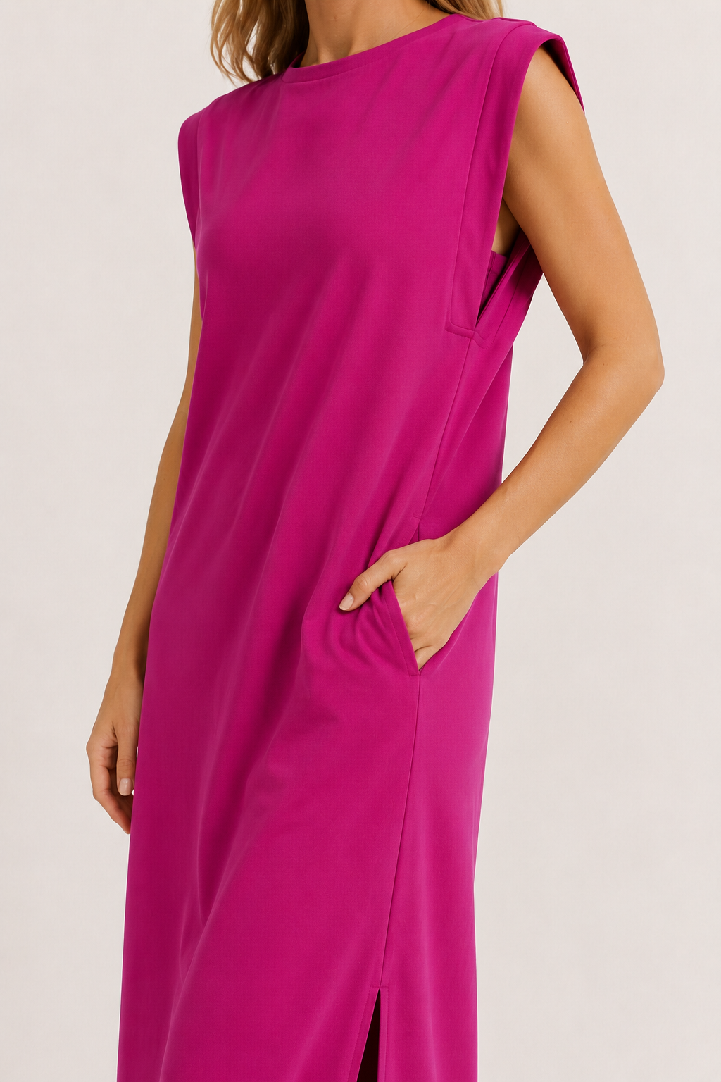 Professional studio shot of a model wearing the Lohnr Rowan Midi dress in Eros Pink, featuring a premium relaxed drape and side split hem.