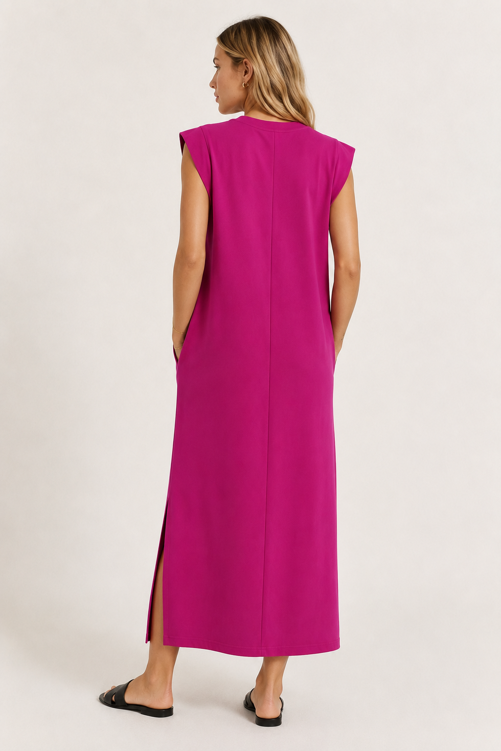 Professional studio shot of a model wearing the Lohnr Rowan Midi dress in Eros Pink, featuring a premium relaxed drape and side split hem.