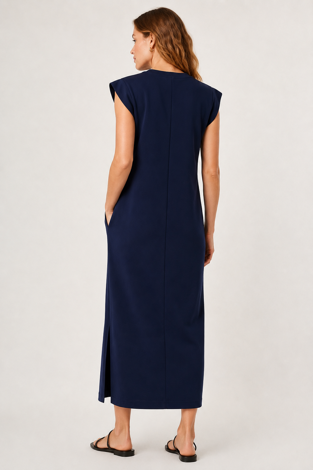 Professional studio shot of a model wearing the Lohnr Rowan Midi dress in Midnight Ink, featuring a premium relaxed drape and side split hem.