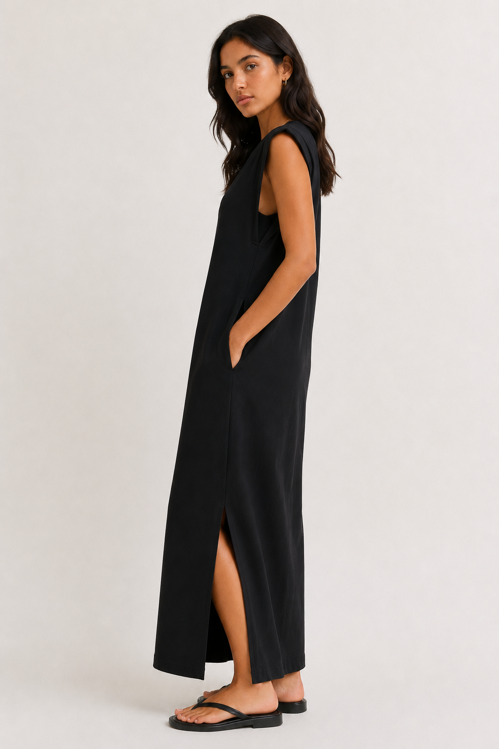Professional studio shot of a model wearing the Lohnr Rowan Midi dress in Onyx, featuring a premium relaxed drape and side split hem.