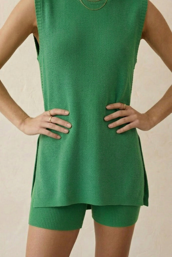 A woman wearing the LOHNR Slouch Tunic Set in Clover green, featuring a sleeveless knit top and matching shorts.