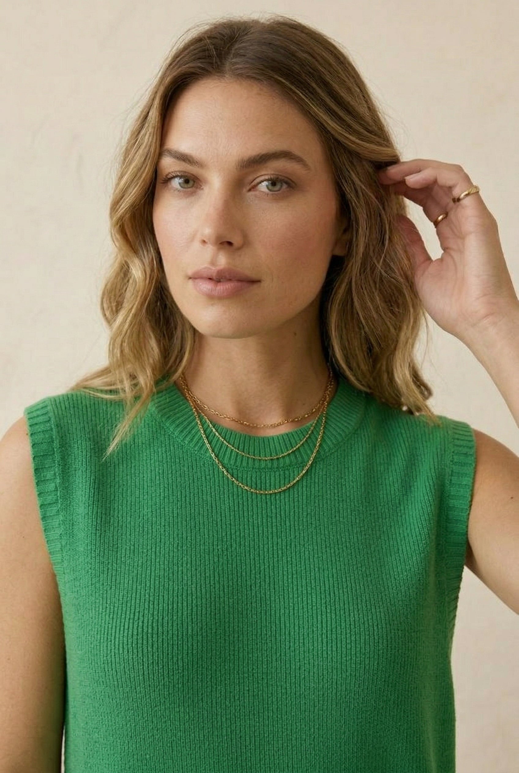 A woman wearing the LOHNR Slouch Tunic Set in Clover green, featuring a sleeveless knit top and matching shorts.