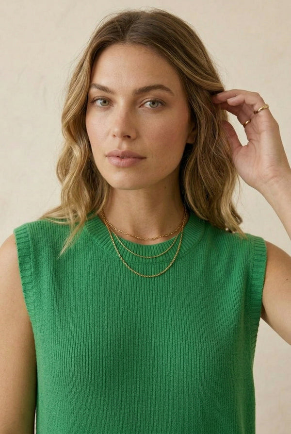 A woman wearing the LOHNR Slouch Tunic Set in Clover green, featuring a sleeveless knit top and matching shorts.