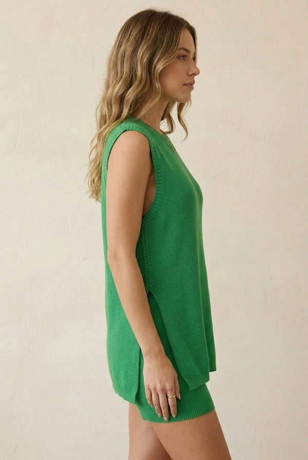 A woman wearing the LOHNR Slouch Tunic Set in Clover green, featuring a sleeveless knit top and matching shorts.