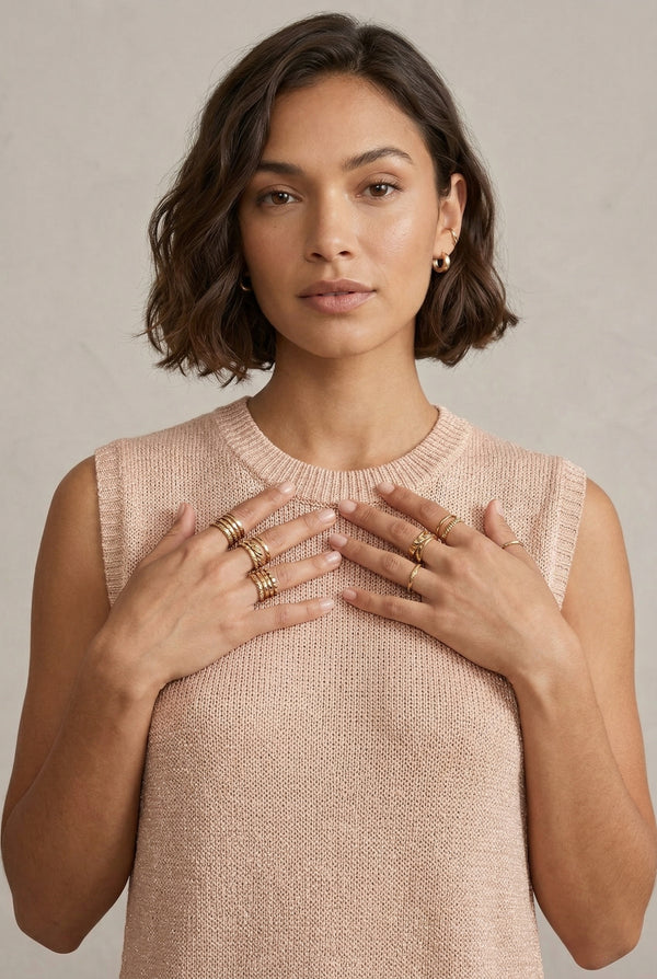 A woman wearing the LOHNR Slouch Tunic Set in Glossy Sand, a neutral beige sleeveless knit loungewear set.