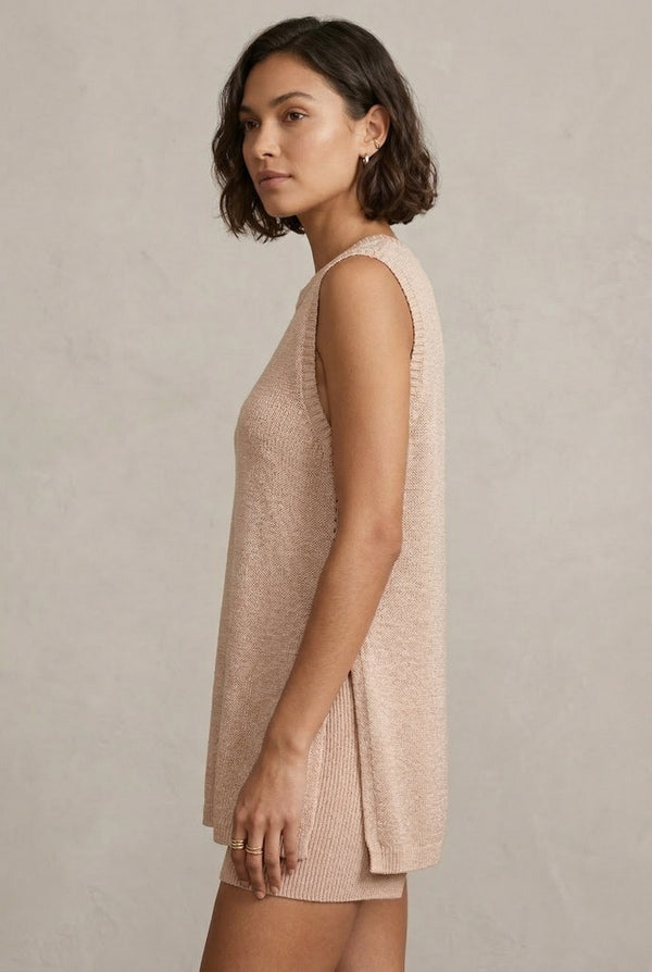 A woman wearing the LOHNR Slouch Tunic Set in Glossy Sand, a neutral beige sleeveless knit loungewear set.
