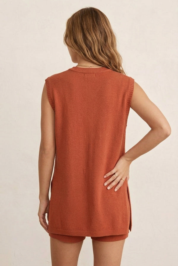 A woman wearing the LOHNR Slouch Tunic Set in Spiced Clay, an earthy terracotta-toned sleeveless knit lounge set.