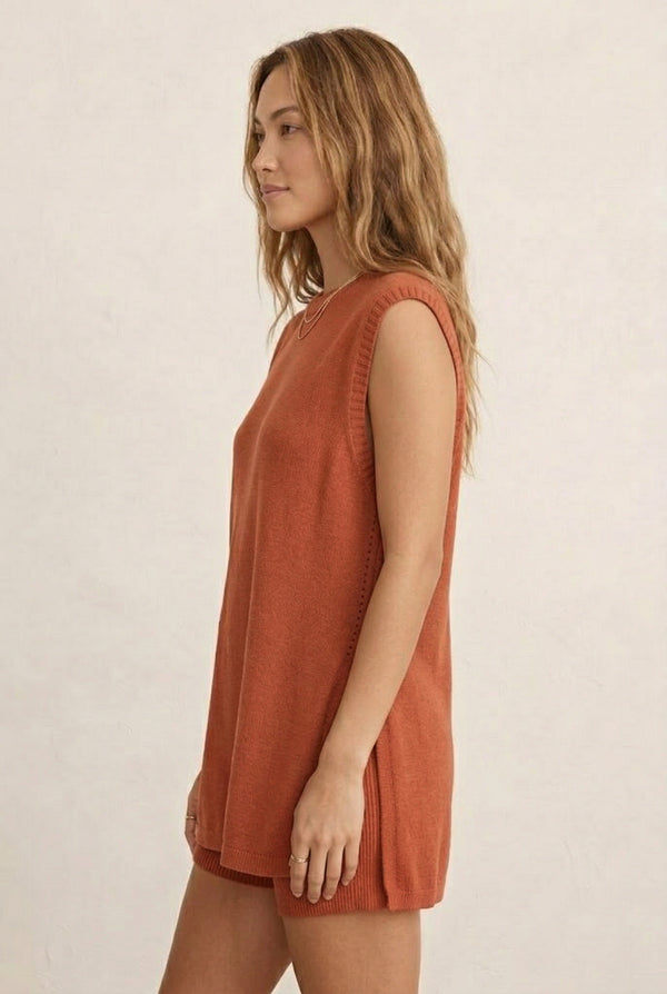 A woman wearing the LOHNR Slouch Tunic Set in Spiced Clay, an earthy terracotta-toned sleeveless knit lounge set.