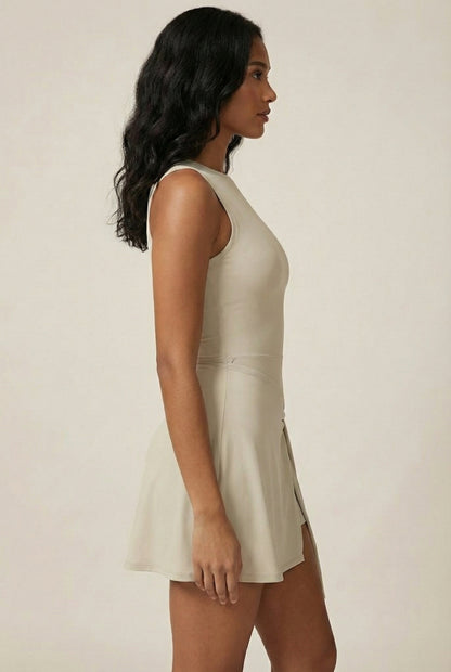 LOHNR The Rally Dress in Beige - Athletic one-piece romper with side-tie wrap skirt and hidden integrated shorts