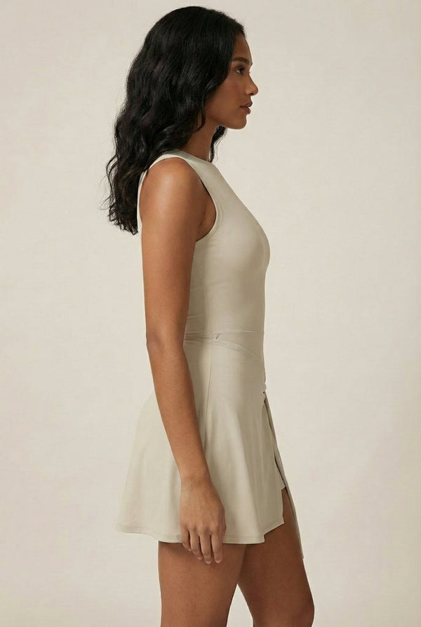 LOHNR The Rally Dress in Beige - Athletic one-piece romper with side-tie wrap skirt and hidden integrated shorts