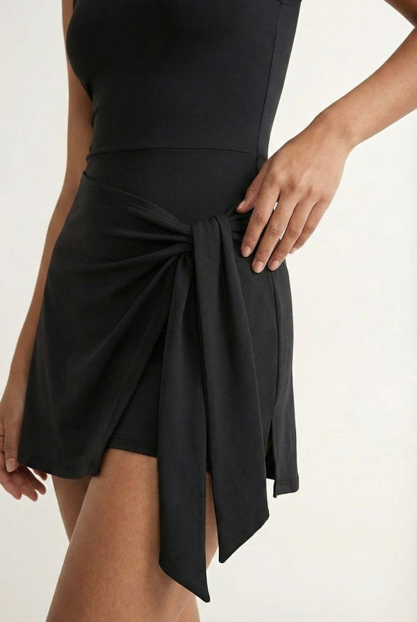 LOHNR The Rally Dress in Black - Athletic one-piece romper with side-tie wrap skirt and hidden integrated shorts