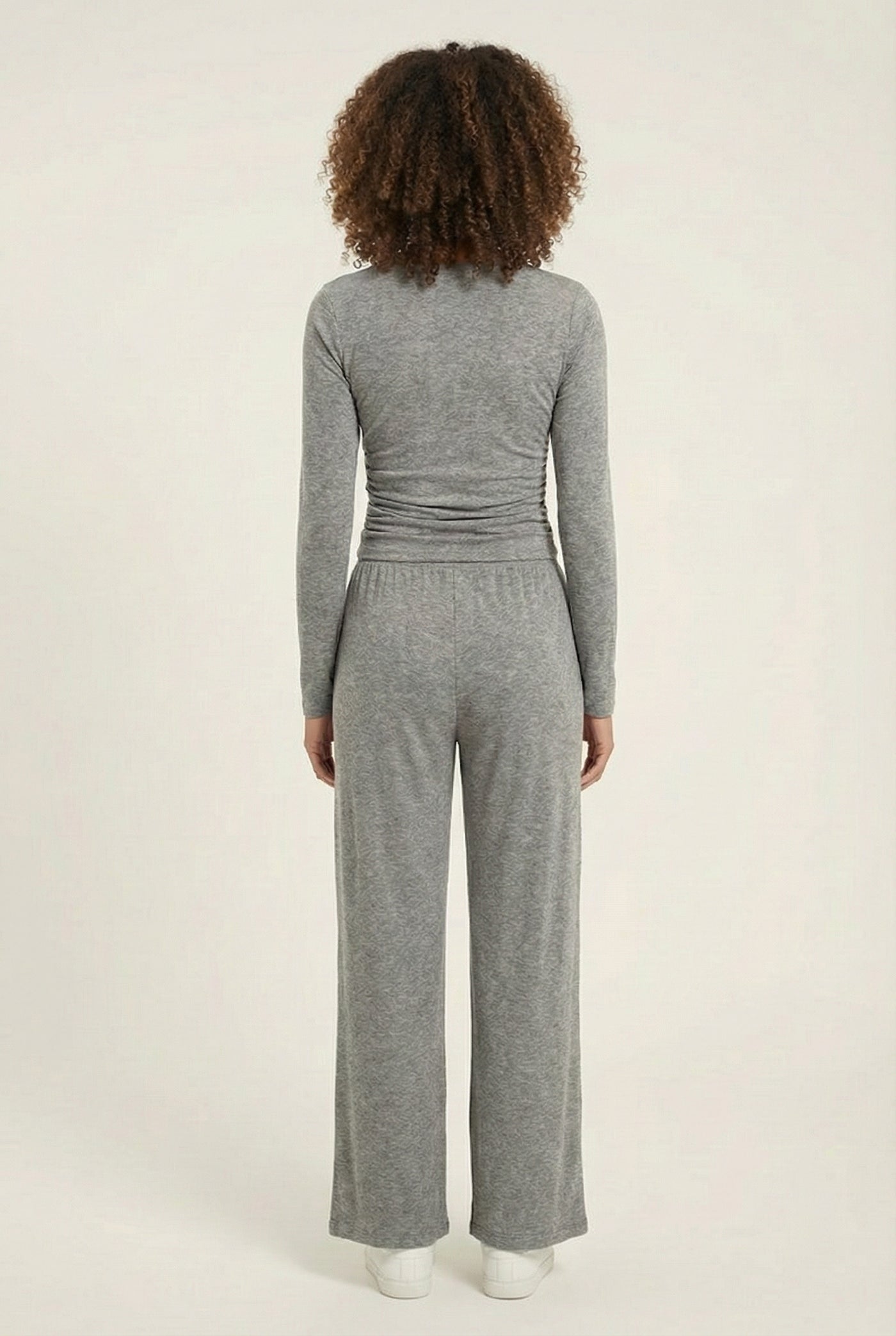 Model wearing The Rive Set sleek stretch lounge set in Graphite by Lohnr, featuring a ruched long-sleeve top and wide-leg drawstring pants