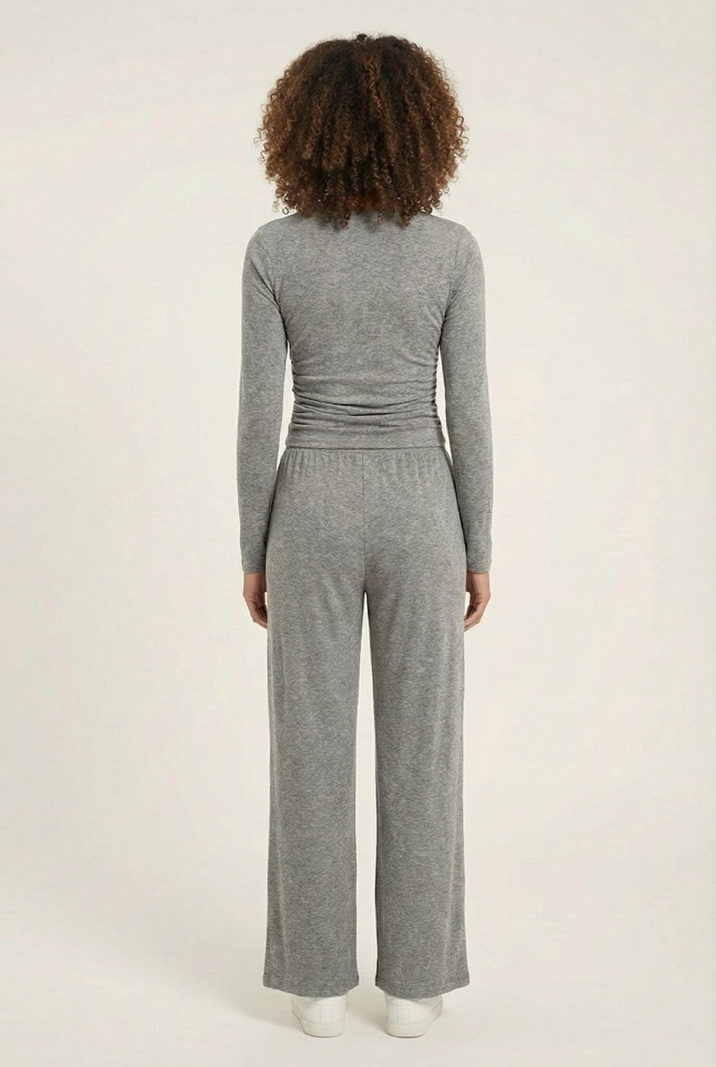 Model wearing The Rive Set sleek stretch lounge set in Graphite by Lohnr, featuring a ruched long-sleeve top and wide-leg drawstring pants