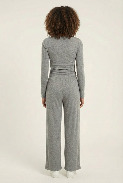 Model wearing The Rive Set sleek stretch lounge set in Graphite by Lohnr, featuring a ruched long-sleeve top and wide-leg drawstring pants
