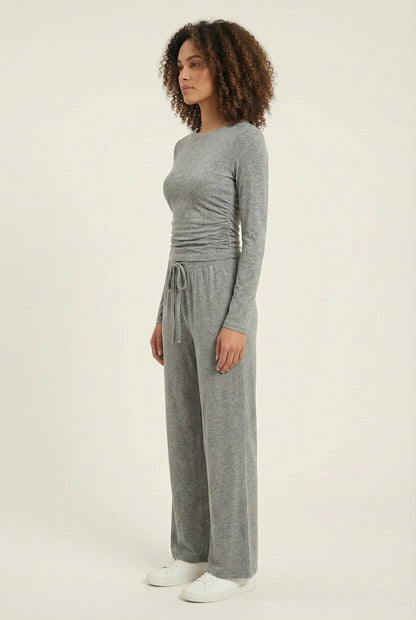 Model wearing The Rive Set sleek stretch lounge set in Graphite by Lohnr, featuring a ruched long-sleeve top and wide-leg drawstring pants