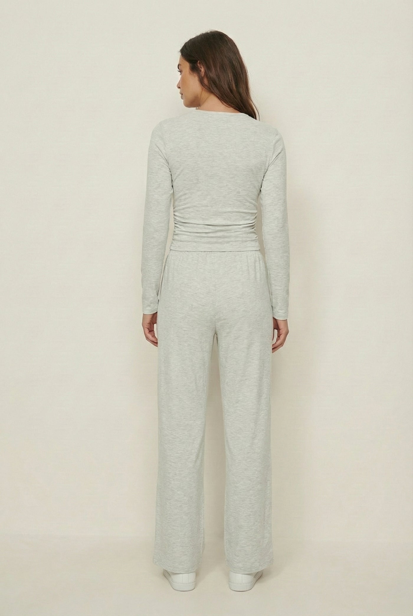 Model wearing The Rive Set sleek stretch lounge set in Mist by Lohnr, featuring a ruched long-sleeve top and wide-leg drawstring pants