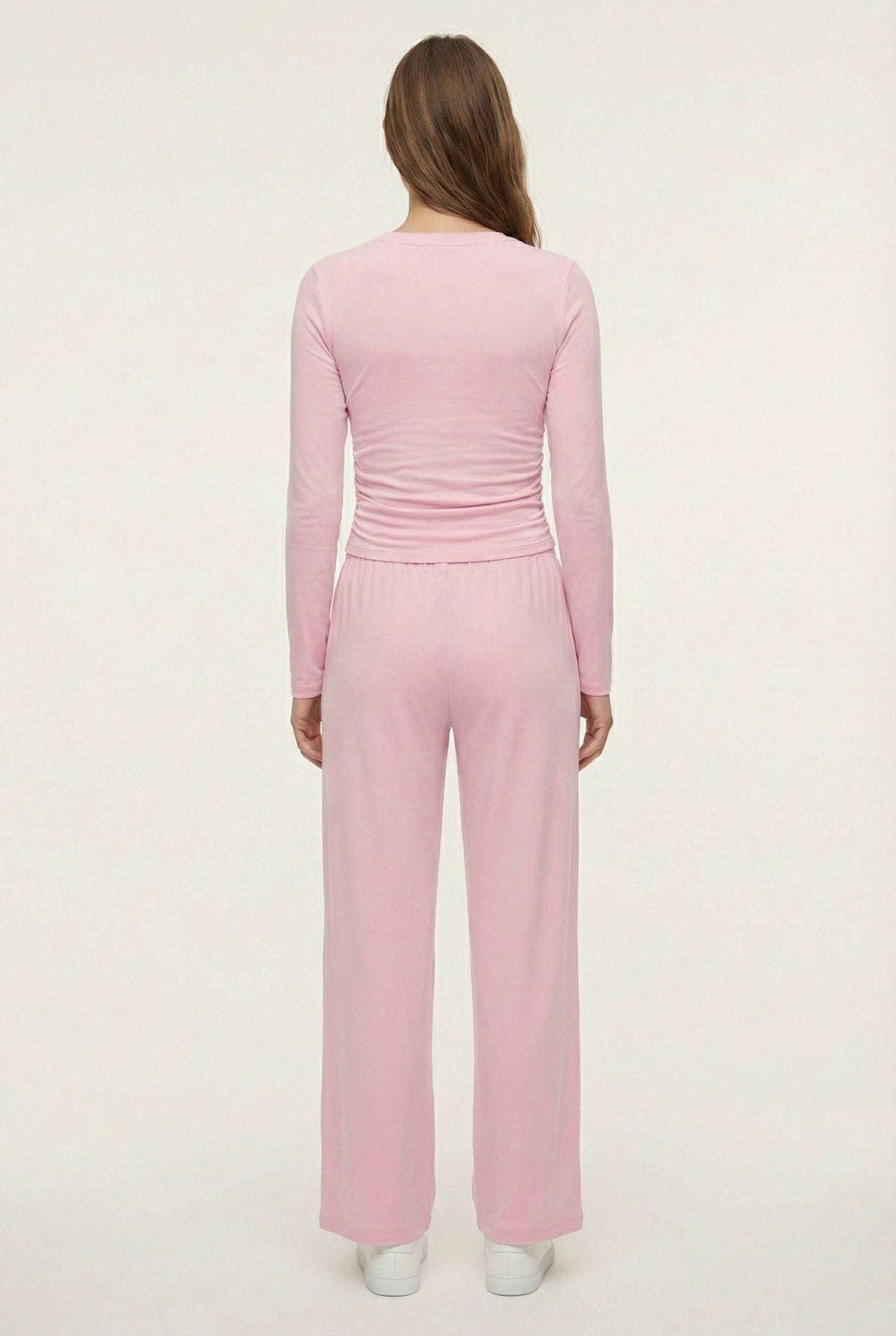 Model wearing The Rive Set sleek stretch lounge set in Rosewater by Lohnr, featuring a ruched long-sleeve top and wide-leg drawstring pants