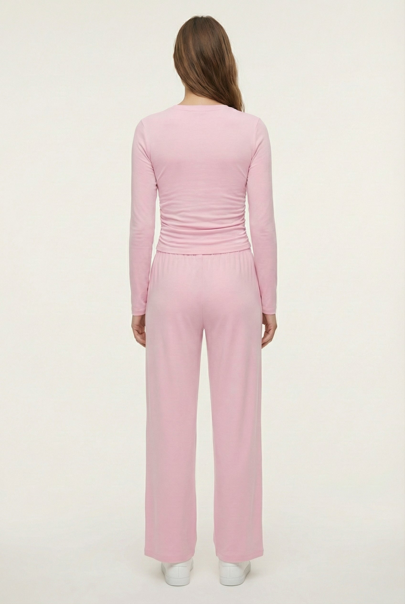 Model wearing The Rive Set sleek stretch lounge set in Rosewater by Lohnr, featuring a ruched long-sleeve top and wide-leg drawstring pants